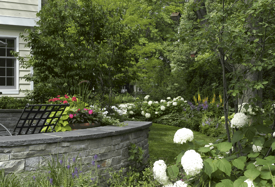 stacked stone seat wall stacked stone seat wall capped with bluestone and surrounded by lush perennial beds