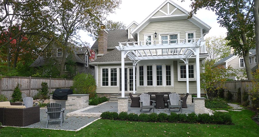 finished-design-build-example rear yard showing pergola, patio, and seating areas.