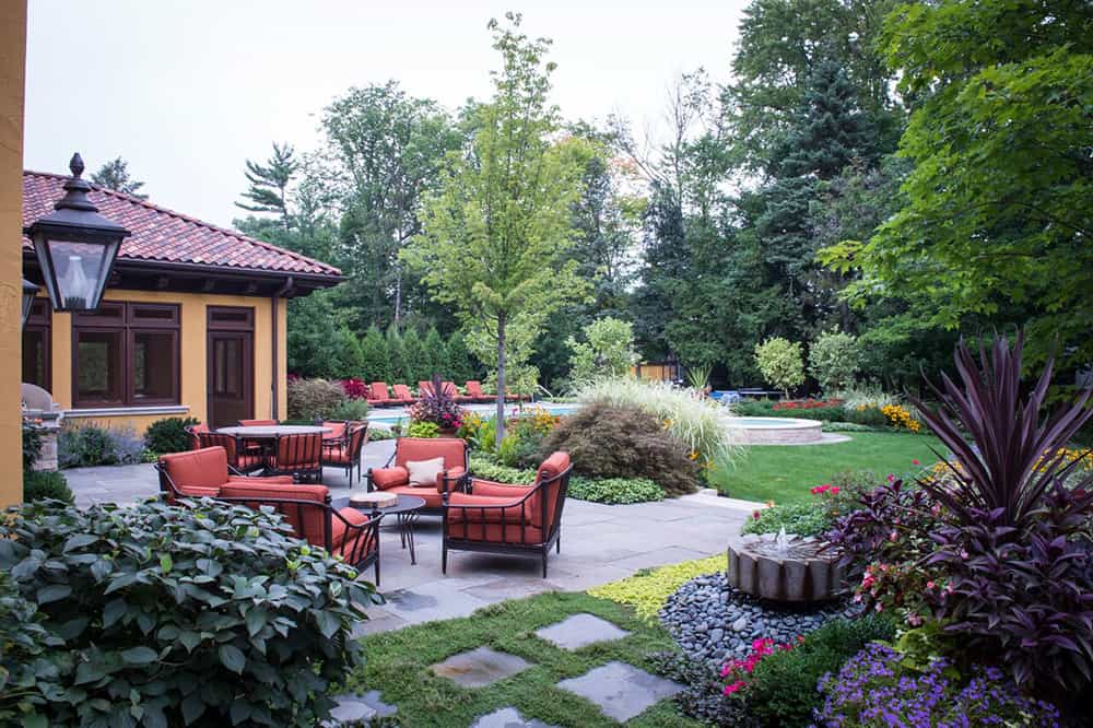 glenview-after Comfortable seating, with tables of varying heights, extend the living space into a cozy outdoor living and dining room. Surrounded by plantings and hardscape, the space provides beautiful views in every direction.