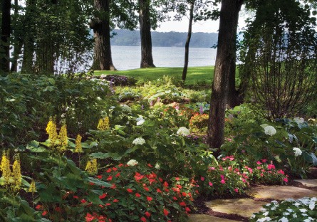 lake-geneva-creek-bed-after As the path meanders past established trees, the plantings give way to a variety of shade-loving perennials, annuals and ground cover. Special attention was paid to choosing interesting shapes, sizes, textures and colors in the flowers and foliage to make every area of the garden visually stimulating.