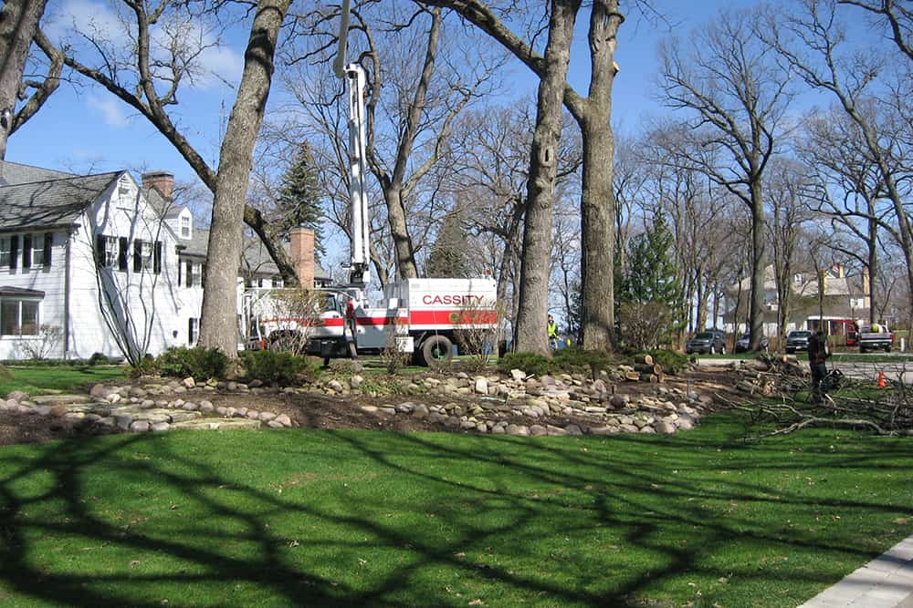 As the first planting bed seen upon approaching the home, it needed to be transformed into a more welcoming focal point. A pond and water feature accompanied by trees, shrubs, perennials and annuals were designed for this space.