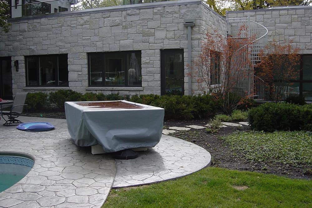 northbrook-before Dated stonework and a few types of grass, shrubs and groundcover repeated throughout the landscape don't enhance the drama of the home.