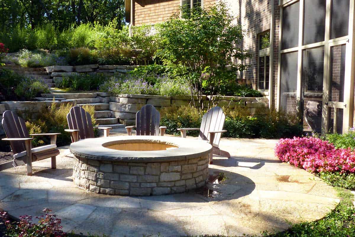 Raised Stone Fire Pit Surrounded By Flagstone Van Zelst