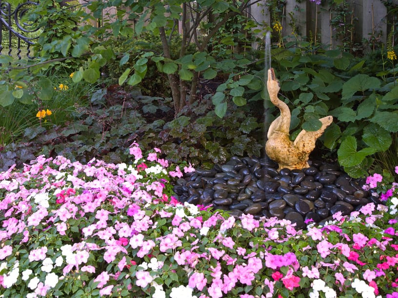 bird-fountain-mexican-pebbles bird fountain with mexican pebbles and large bed of impatiens