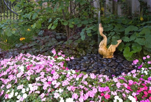 bird fountain on river rocks